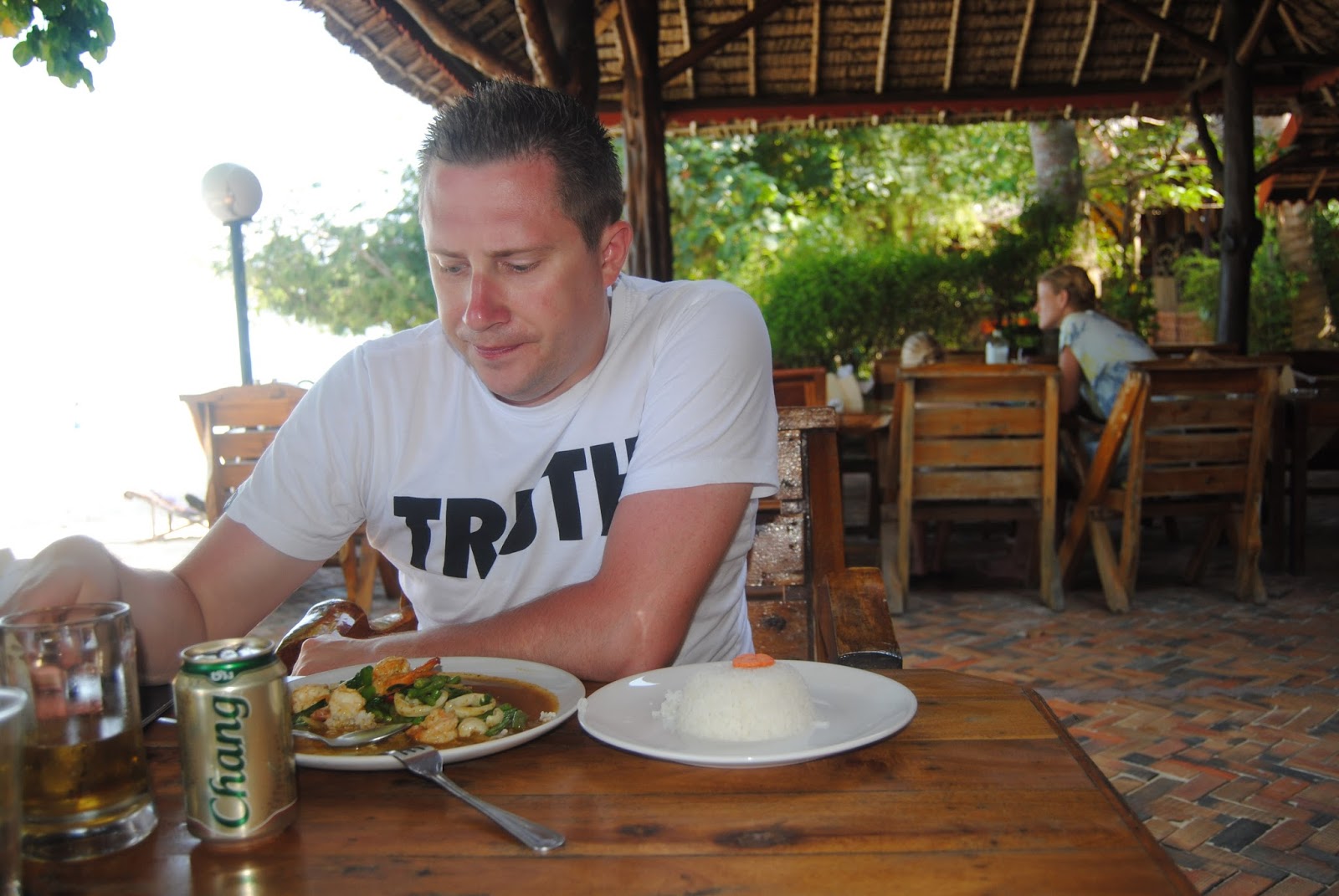 Stir-fried seafood with rice and a Chang beer at a beach restaurant in Thailand