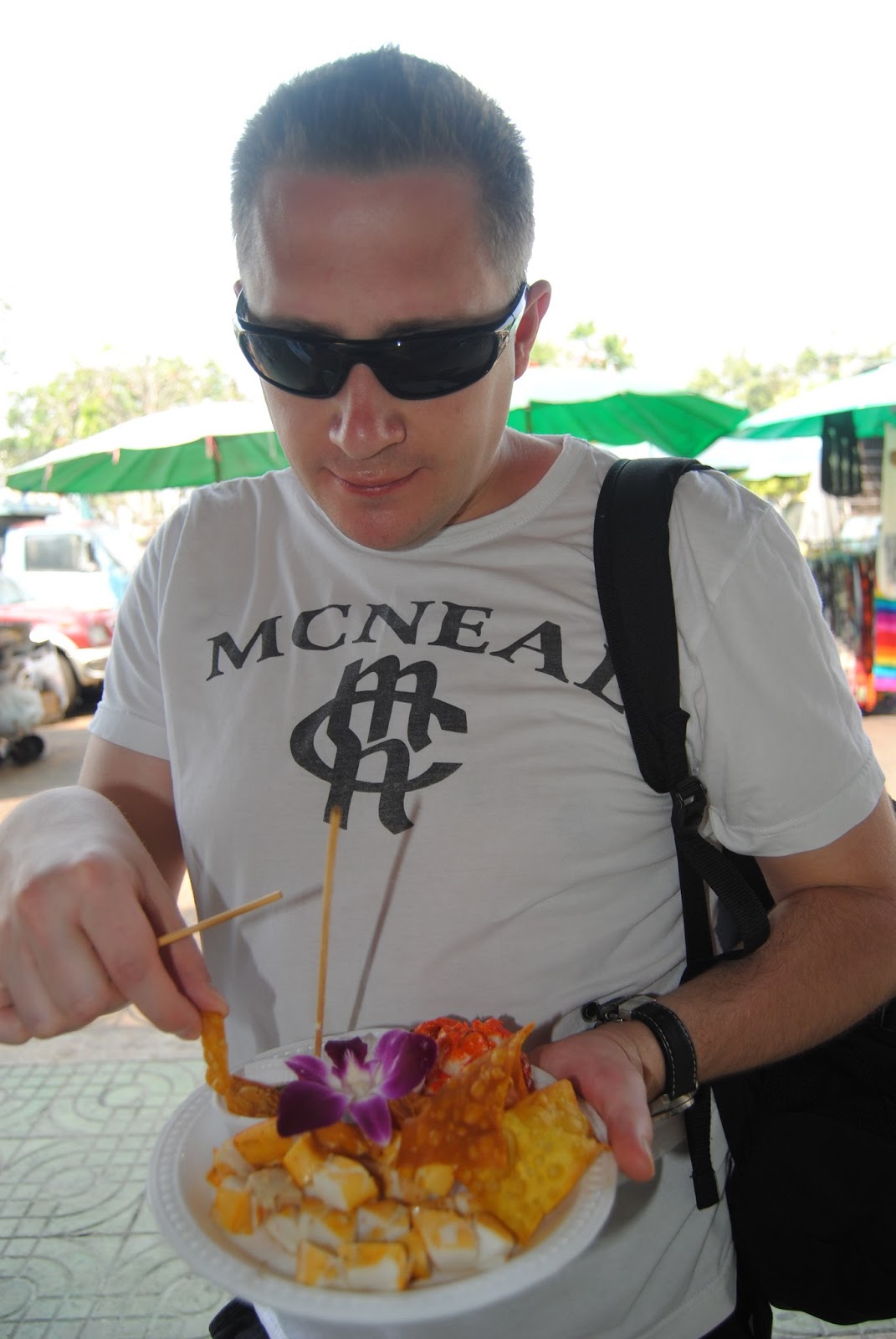 Eating fried street snacks at a market in Thailand